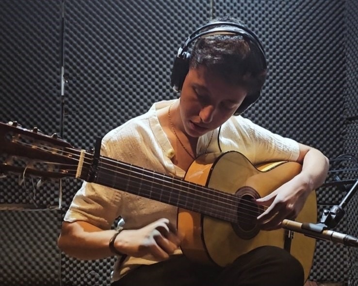 Arash Farahmand playing guitar in the studio